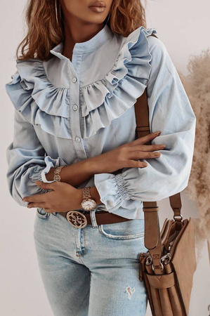Niebieska, sztruksowa bluzka zdobiona falbaną.